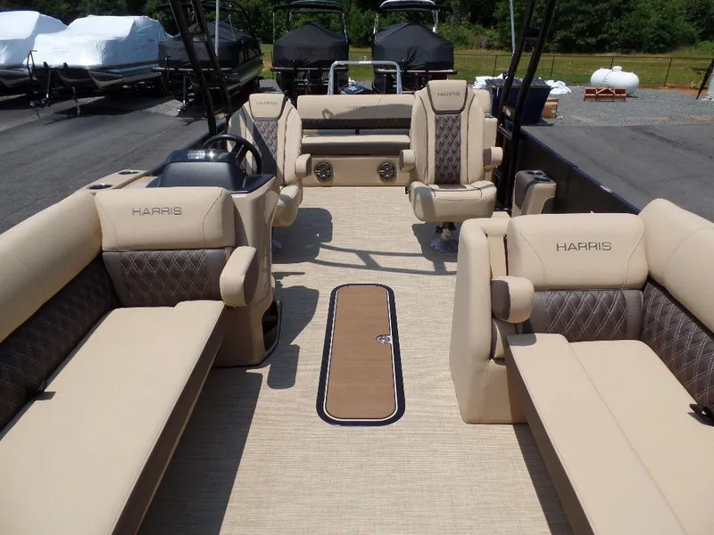 Slide: The Image of 2025 Harris SUNLINER SP 250 pontoon boat interior with beige seating and modern design. - 4