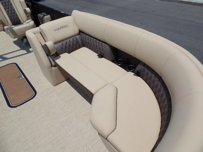 Slide: The Image of 2025 Harris SUNLINER SP 250 boat interior with beige seating and cup holders. - 5