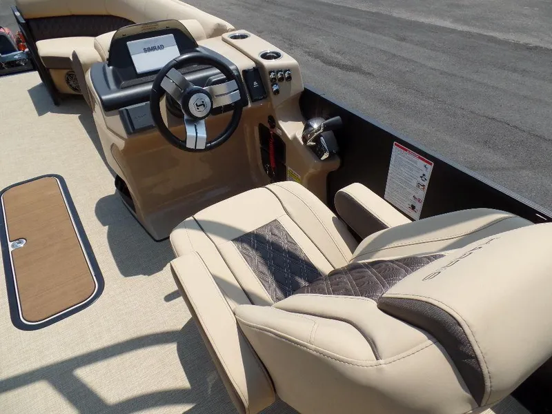 Slide: The Image of 2025 Harris SUNLINER SP 250 boat interior with beige seating and modern steering console. - 9