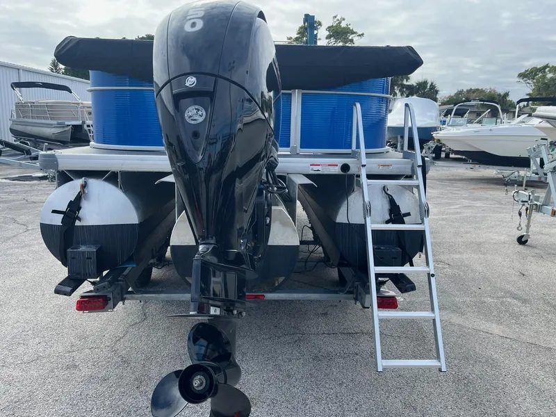 Slide: The Image of 2022 Godfrey Sweetwater 2286 C pontoon boat, rear view with motor and ladder. - 4