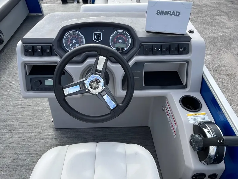 Slide: The Image of 2022 Godfrey Sweetwater 2286 C boat dashboard with steering wheel and Simrad display. - 5