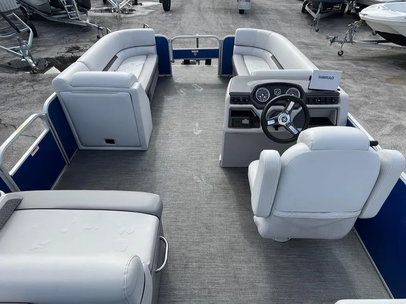 Slide: The Image of 2022 Godfrey Sweetwater 2286 C pontoon boat interior with plush seating and modern helm. - 6