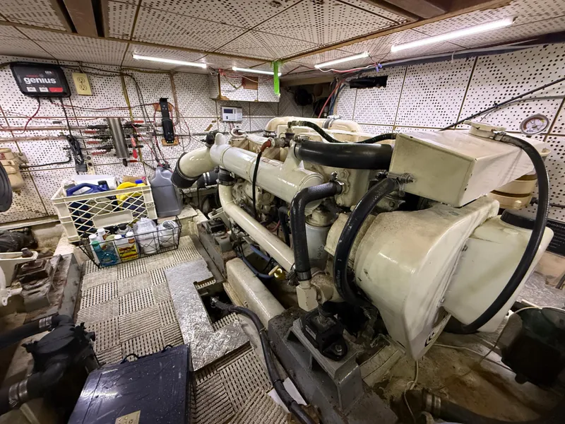 Slide: The Image of Engine room of a 1986 Jefferson Sundeck yacht, featuring mechanical components and storage. - 13