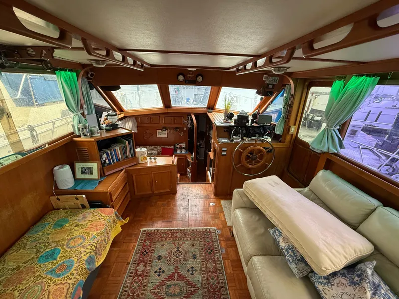 Slide: The Image of Interior of a 1986 Jefferson Sundeck yacht with cozy seating and nautical decor. - 2