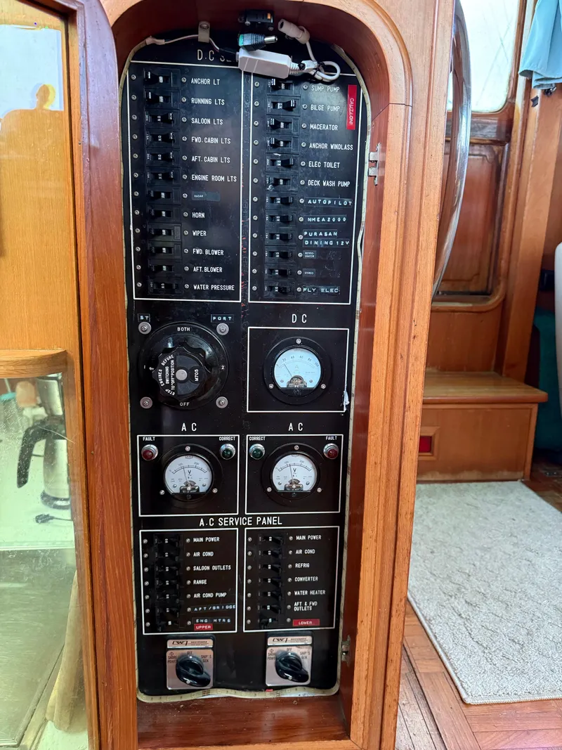 Slide: The Image of Electrical control panel on a 1986 Jefferson Sundeck boat, featuring AC and DC switches. - 6