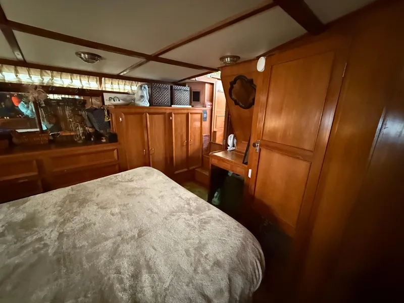 Slide: The Image of 1986 Jefferson Sundeck interior with wooden cabinetry and cozy bedroom setup. - 8