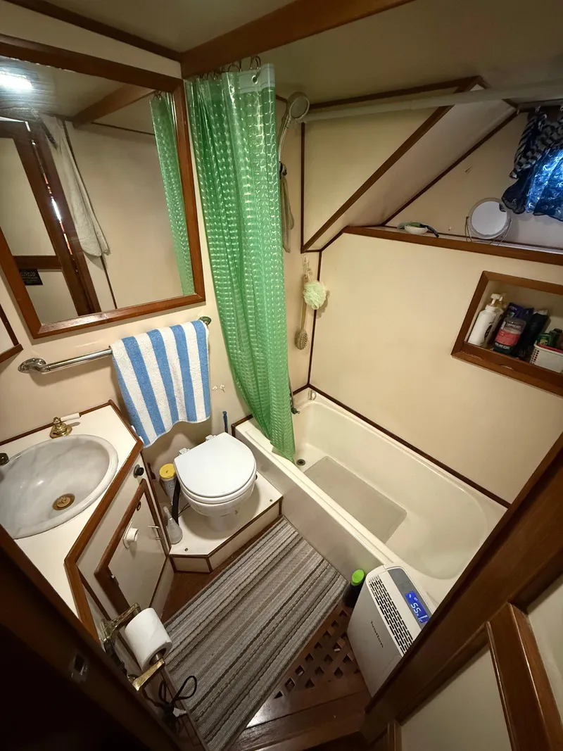 Slide: The Image of Bathroom interior of 1986 Jefferson Sundeck yacht with shower, toilet, and sink. - 9
