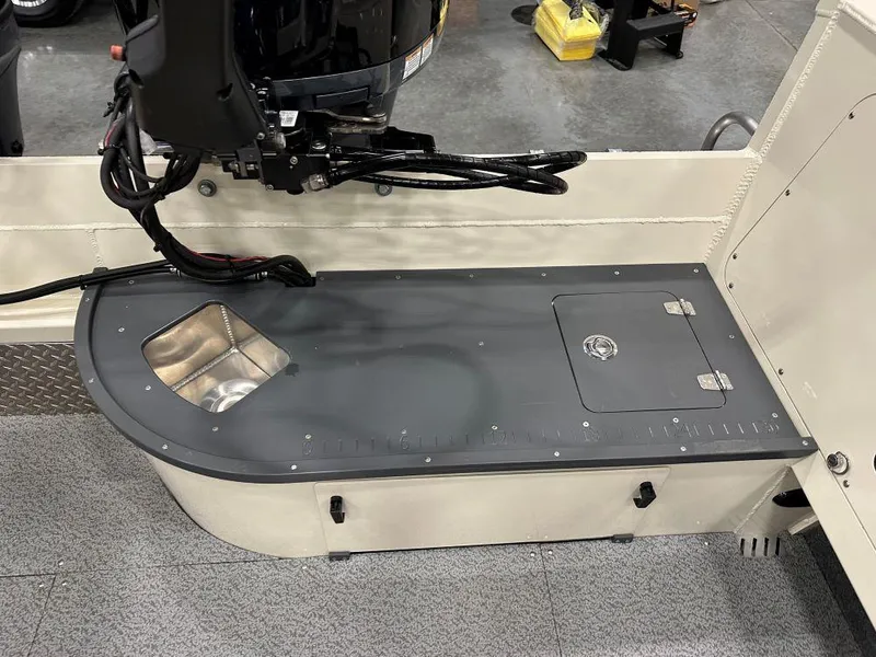 Slide: The Image of 2025 Hewescraft 200 Pioneer boat interior with motor and storage compartment. - 8