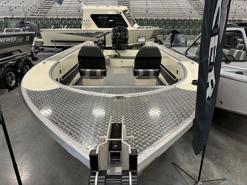 Slide: The Image of 2025 Hewescraft 200 Pioneer boat with aluminum deck, displayed indoors. - 9