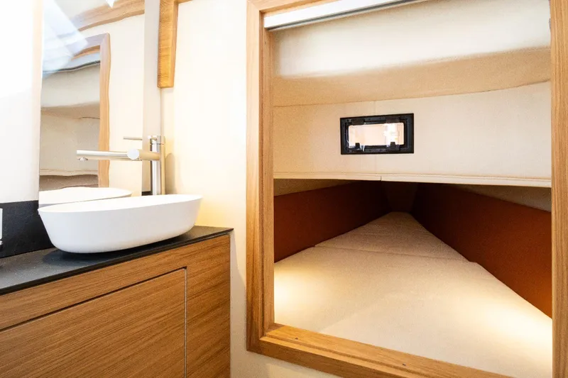 Slide: The Image of Interior of 2025 AlCustom LIPARI 31 yacht, featuring a modern bathroom and cozy sleeping area. - 21
