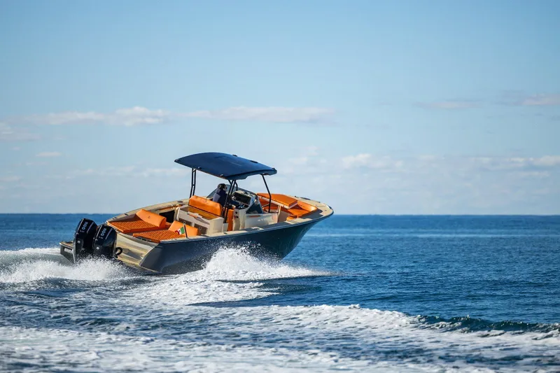 Slide: The Image of 2025 AlCustom LIPARI 31 boat cruising on open sea with clear blue sky. - 6