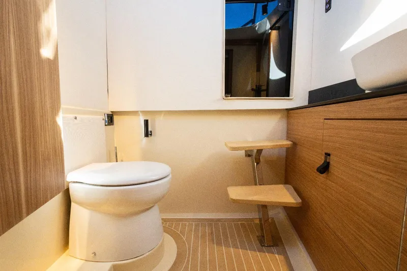 Slide: The Image of Modern bathroom interior in 2025 AlCustom LIPARI 31 yacht, featuring wood accents and compact design. - 24