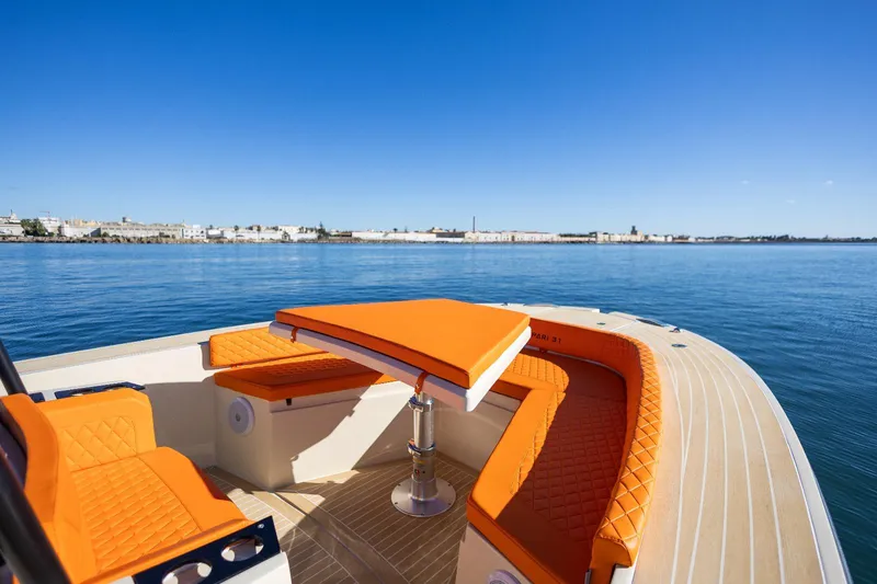 Slide: The Image of Luxury AlCustom LIPARI 31 boat with orange seating, cruising on calm waters, 2025 model. - 8
