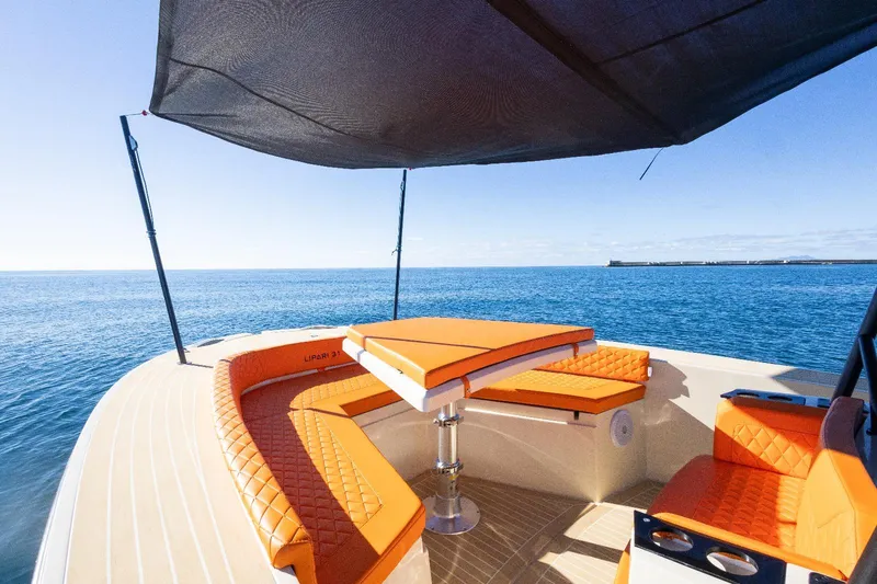 Slide: The Image of Luxury AlCustom LIPARI 31 boat with orange seating, ocean view, 2025 model. - 9
