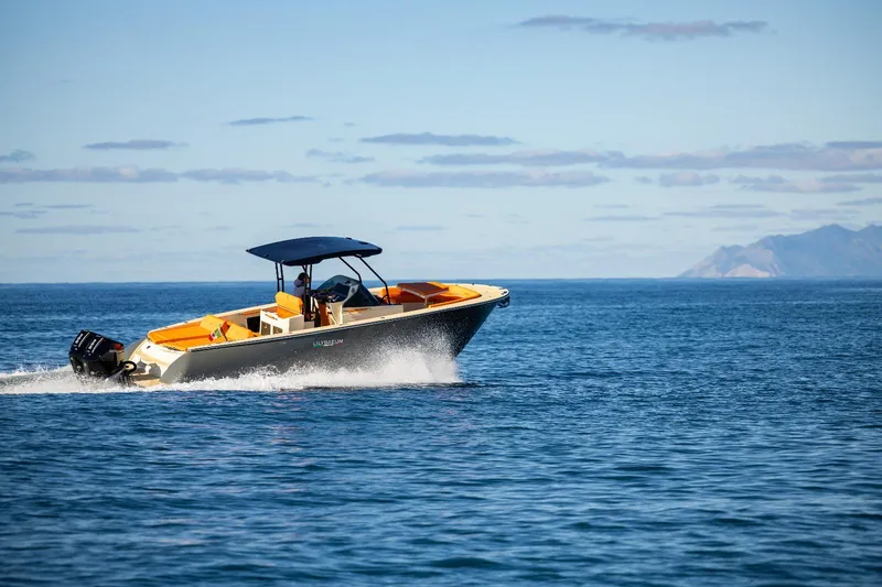 Slide: The Image of AlCustom LIPARI 31 boat cruising on open sea, 2025 model. - 1