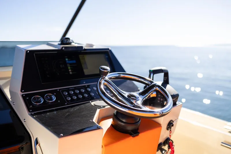 Slide: The Image of 2025 AlCustom LIPARI 31 boat helm with steering wheel and control panel, ocean view. - 14