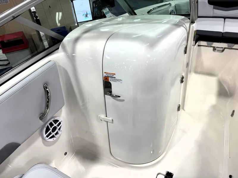 Slide: The Image of 2025 Robalo R207 Dual Console interior with white seating and storage compartment. - 11