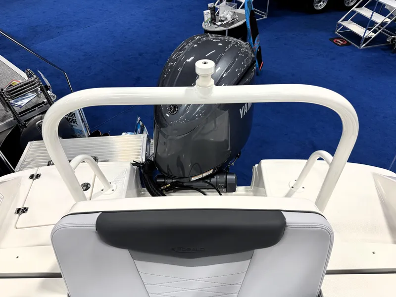 Slide: The Image of 2025 Robalo R207 Dual Console boat with Yamaha outboard motor, displayed indoors. - 20