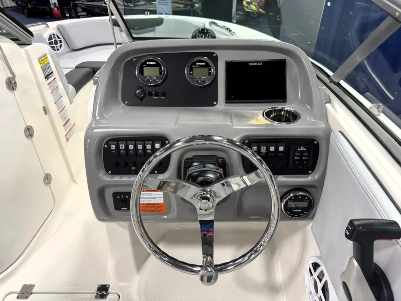 Slide: The Image of 2025 Robalo R207 Dual Console boat dashboard with steering wheel and control panel. - 9