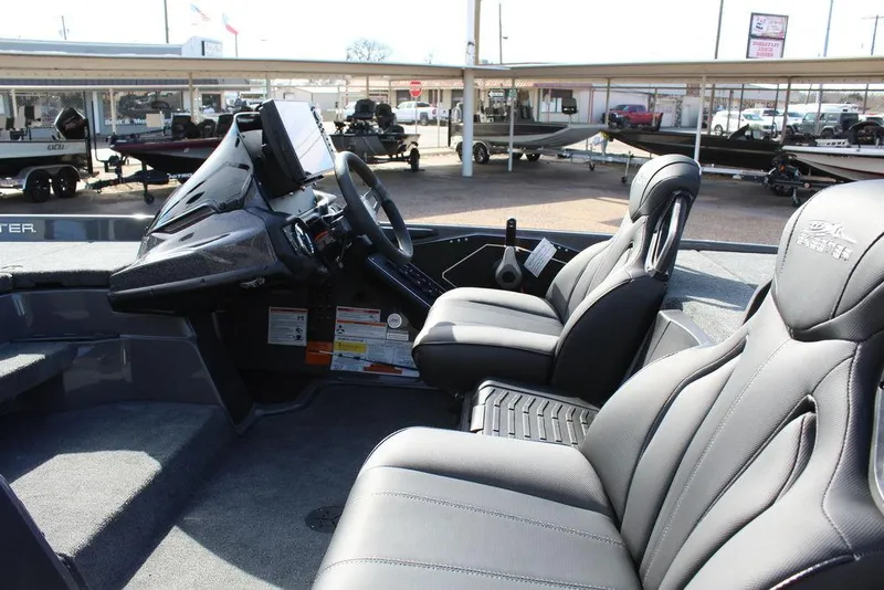 Slide: The Image of 2025 Skeeter ZXR21 boat interior with modern seating and dashboard controls. - 11