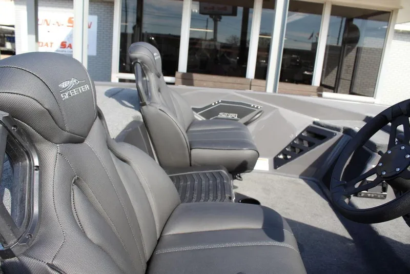 Slide: The Image of 2025 Skeeter ZXR21 boat interior with gray seats and steering wheel. - 16