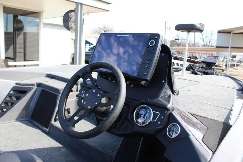 Slide: The Image of 2025 Skeeter ZXR21 boat dashboard with steering wheel and advanced navigation display. - 17