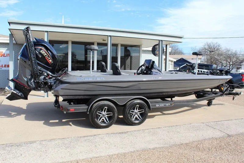 Slide: The Image of 2025 Skeeter ZXR21 boat on trailer, parked outside dealership. - 3