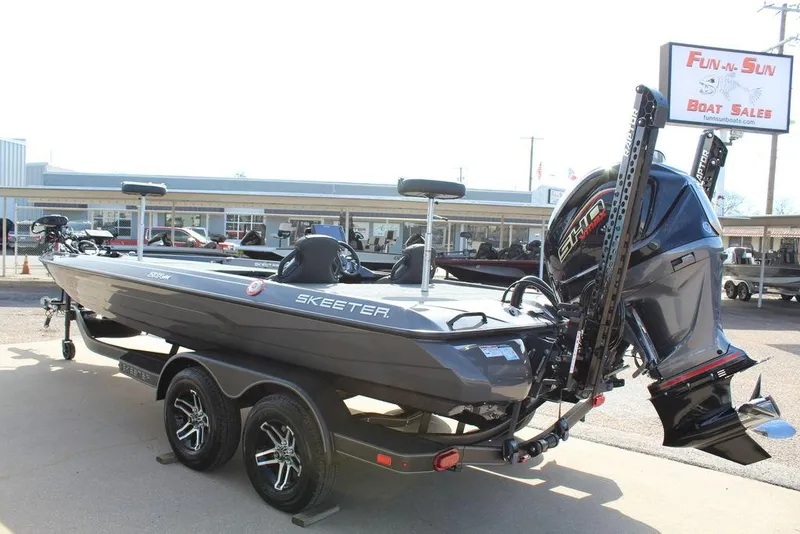 Slide: The Image of 2025 Skeeter ZXR21 boat at dealership, featuring powerful outboard motor and sleek design. - 6