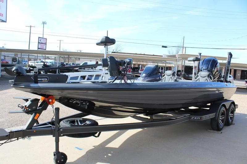 Slide: The Image of 2025 Skeeter ZXR21 boat on trailer, parked outdoors, showcasing sleek design and modern features. - 9