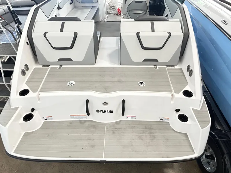Slide: The Image of 2024 Yamaha Boats AR 220, rear view, showcasing spacious deck and seating area. - 3