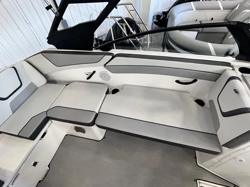Slide: The Image of 2024 Yamaha Boats AR 220 interior seating with sleek gray and white design. - 4