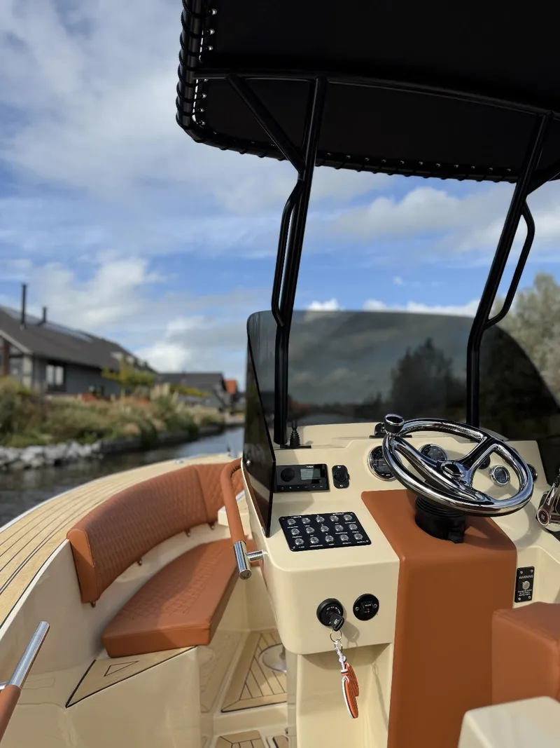 Slide: The Image of AlCustom Levanzo 25 boat interior, 2025 model, featuring sleek design and modern controls. - 11