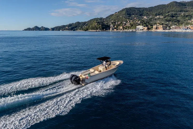 Slide: The Image of 2025 AlCustom Levanzo 25 boat cruising on scenic coastal waters. - 18