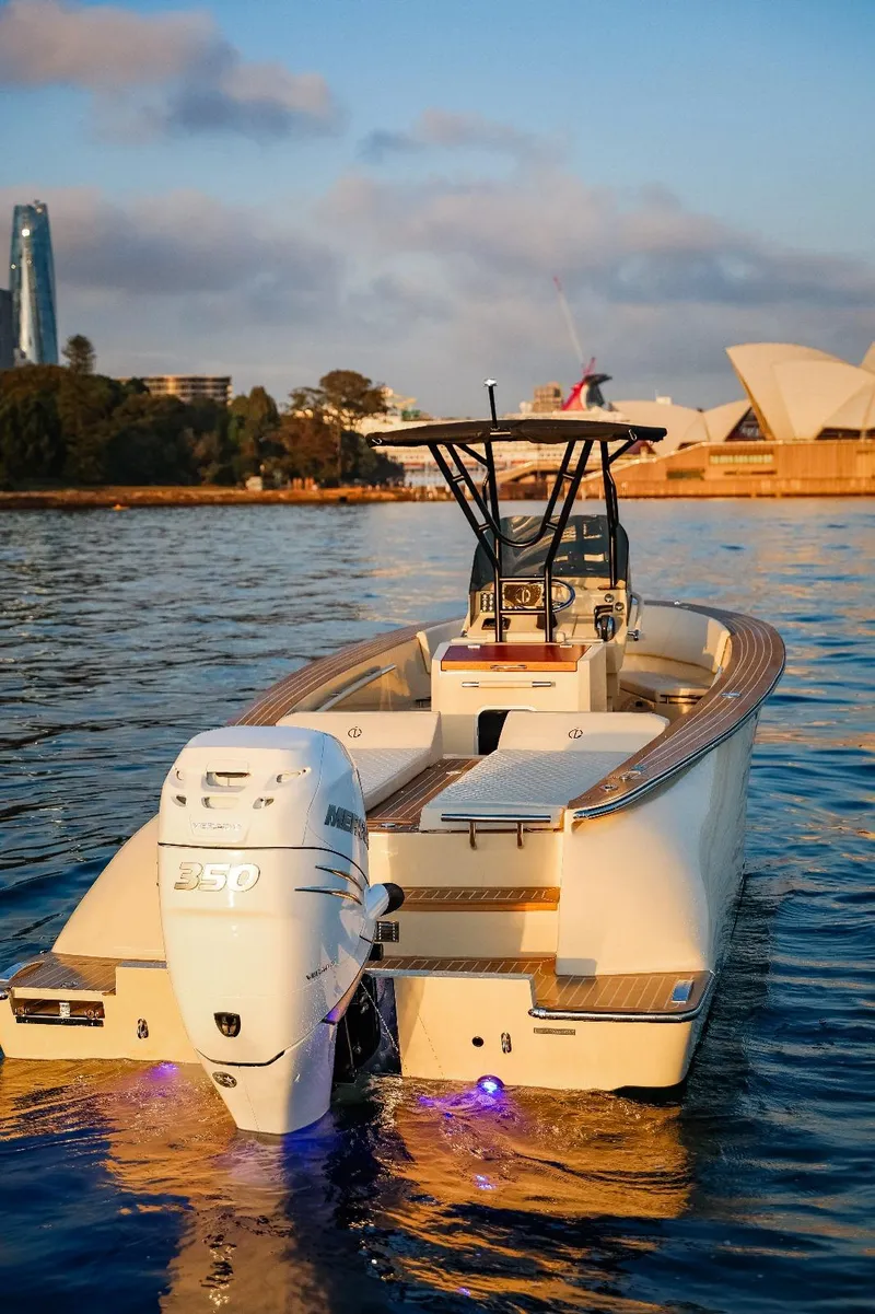 Slide: The Image of 2025 AlCustom Levanzo 25 boat on water at sunset, cityscape in background. - 24