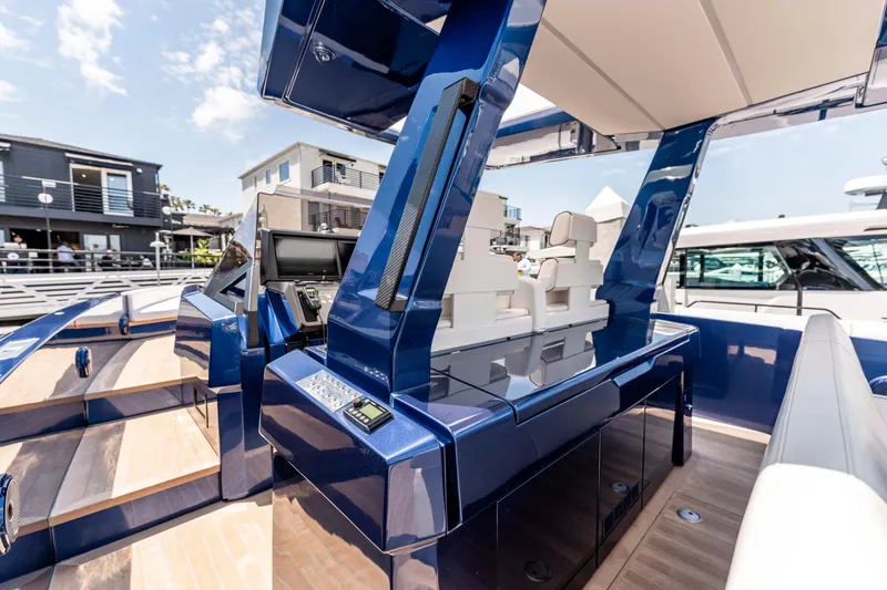 Slide: The Image of 2023 Wally Wallytender 48 yacht cruising in a scenic harbor. - 12