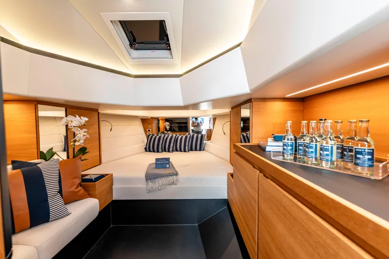 Slide: The Image of 2023 Wally Wallytender 48 yacht with sleek blue deck, docked in a marina. - 23