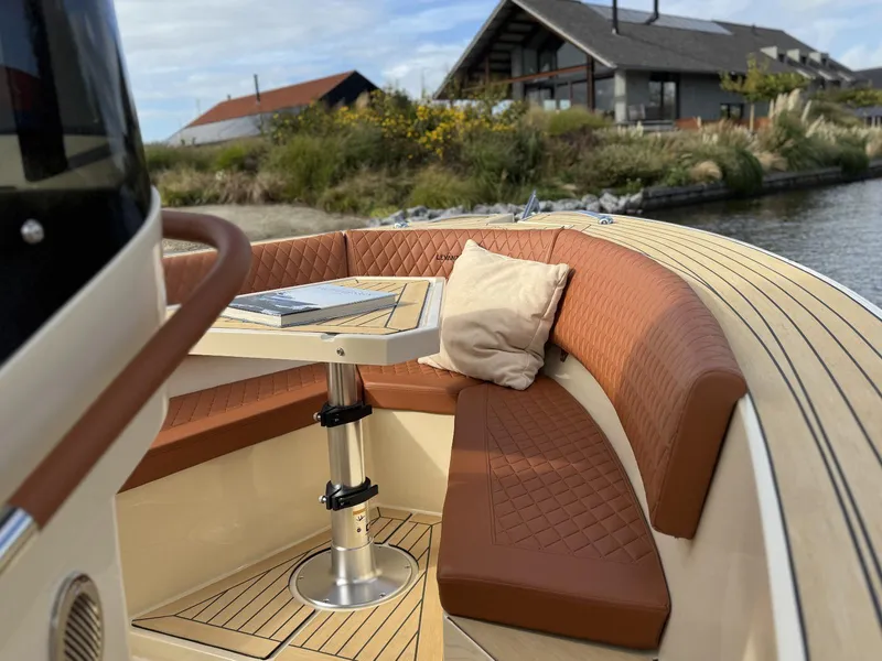 Slide: The Image of Luxurious AlCustom Levanzo 25 boat interior with leather seating and table, 2025 model. - 10