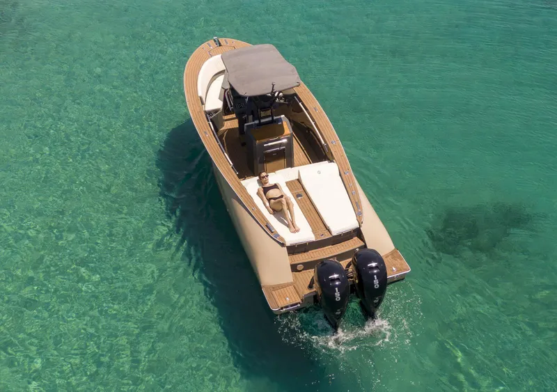 Slide: The Image of 2025 AlCustom Levanzo 25 boat on clear turquoise water, featuring dual outboard engines. - 8