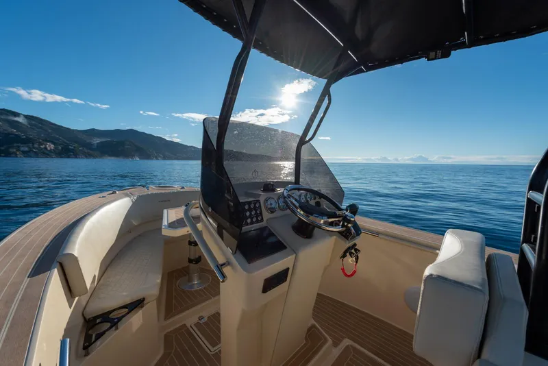 Slide: The Image of AlCustom Levanzo 25 boat interior, 2025 model, with steering console and ocean view. - 13