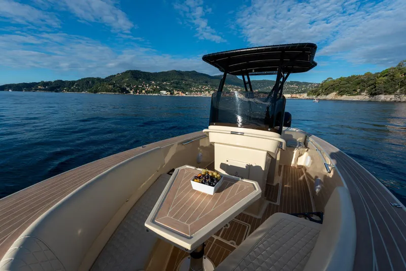 Slide: The Image of AlCustom Levanzo 25 boat, 2025 model, cruising on a scenic lake with clear skies. - 9