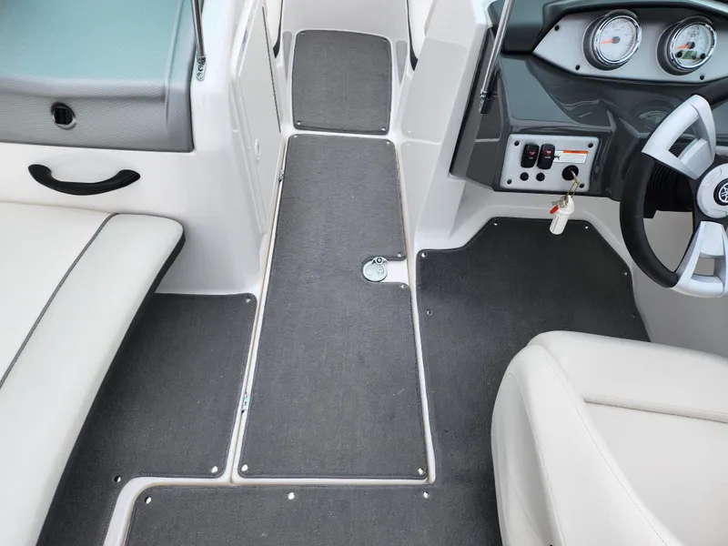 Slide: The Image of 2014 Yamaha Boats AR190 interior with steering wheel and seating area. - 11