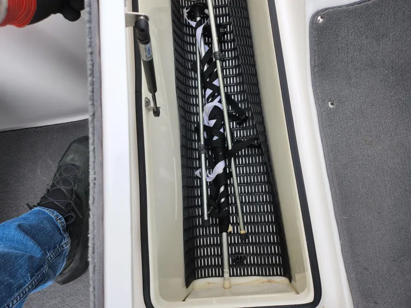 Slide: The Image of 2014 Yamaha AR190 boat storage compartment with equipment inside. - 12