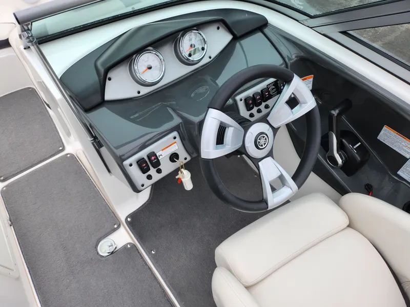 Slide: The Image of 2014 Yamaha Boats AR190 dashboard with steering wheel and gauges. - 14