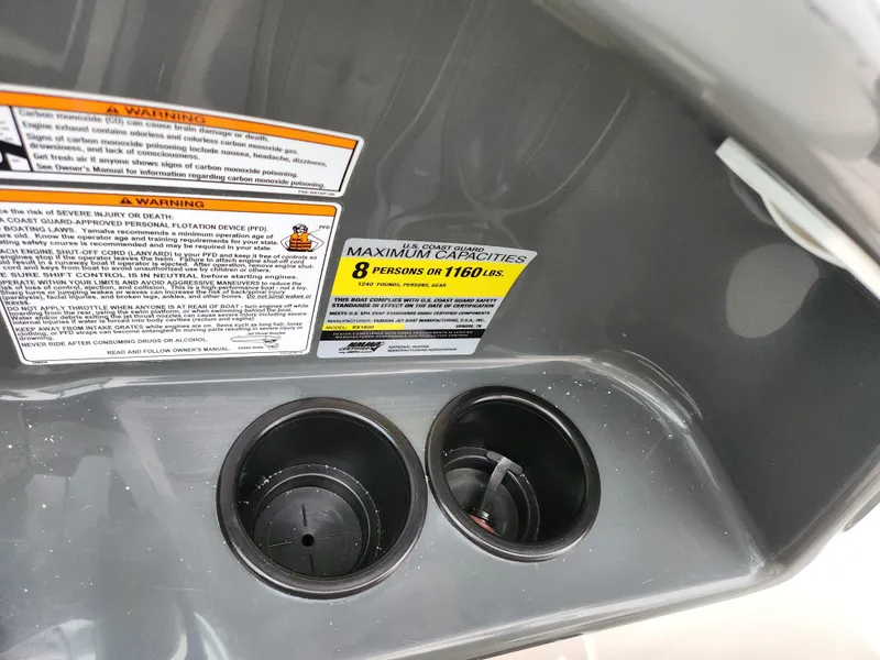 Slide: The Image of 2014 Yamaha Boats AR190 interior with cup holders and safety capacity labels. - 15