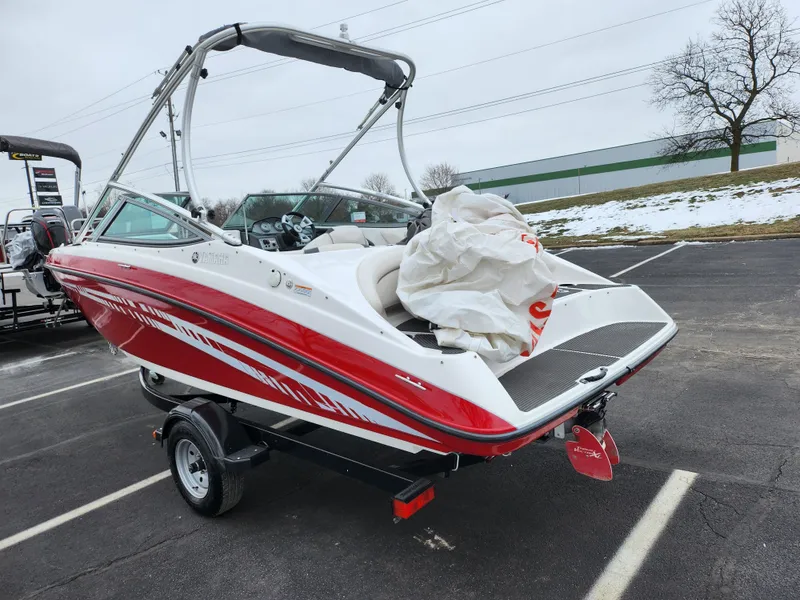 Slide: The Image of 2014 Yamaha AR190 boat in parking lot, red and white design, on trailer. - 3