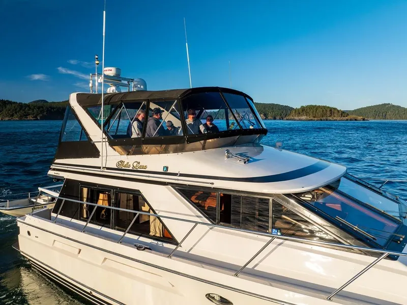 Slide: The Image of 1990 Ocean Alexander 48 Cockpit Motoryacht cruising on a sunny day with passengers onboard. - 10