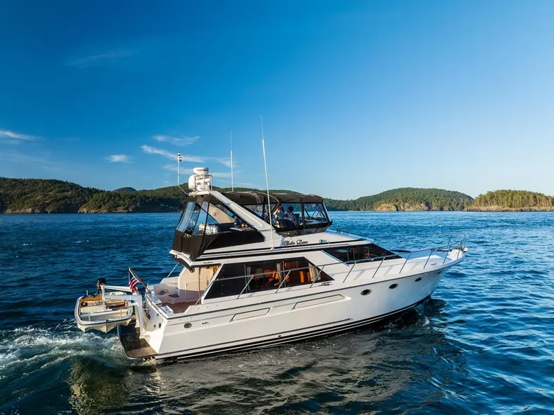 Slide: The Image of 1990 Ocean Alexander 48 Cockpit Motoryacht cruising on a scenic blue ocean. - 11