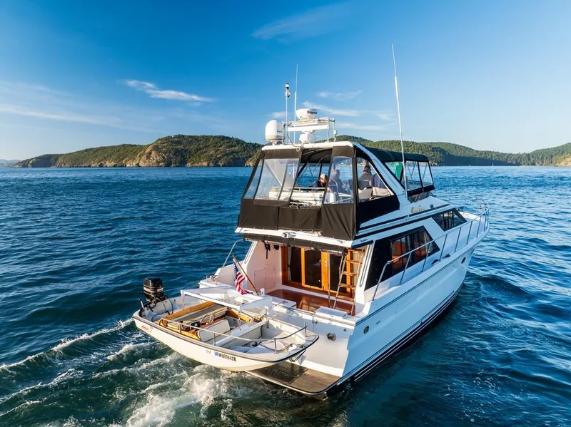 Slide: The Image of 1990 Ocean Alexander 48 Cockpit Motoryacht cruising on scenic blue waters. - 13