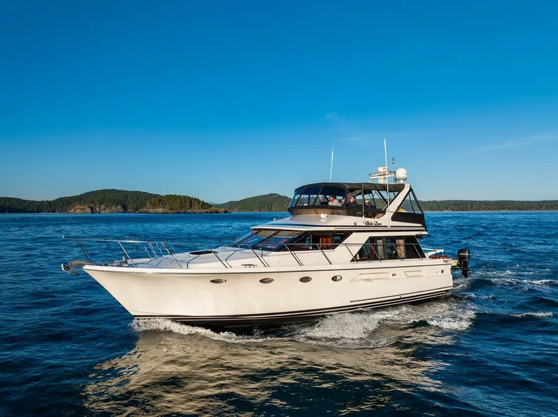 Slide: The Image of 1990 Ocean Alexander 48 Cockpit Motoryacht cruising on open water. - 2