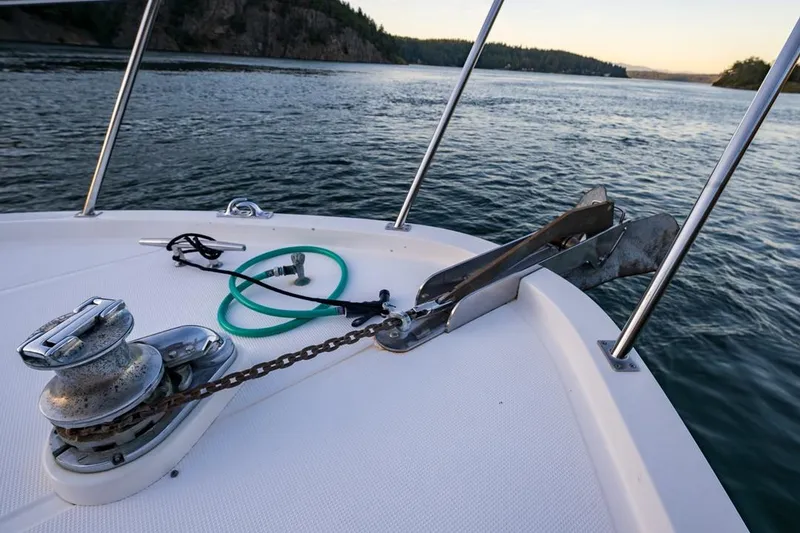 Slide: The Image of Bow of 1990 Ocean Alexander 48 Cockpit Motoryacht with anchor and winch, scenic water view. - 23